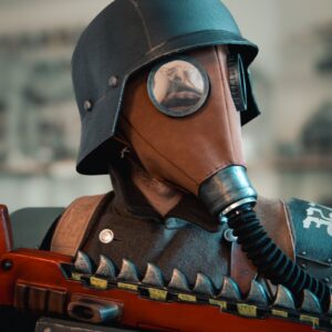 A man in a gas mask holding a radio